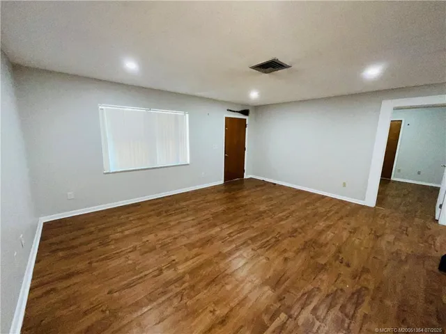 a room with pool table and chairs