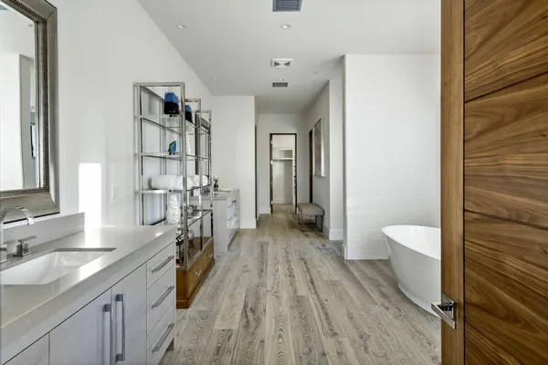 a spacious bathroom with a granite countertop sink a toilet and shower