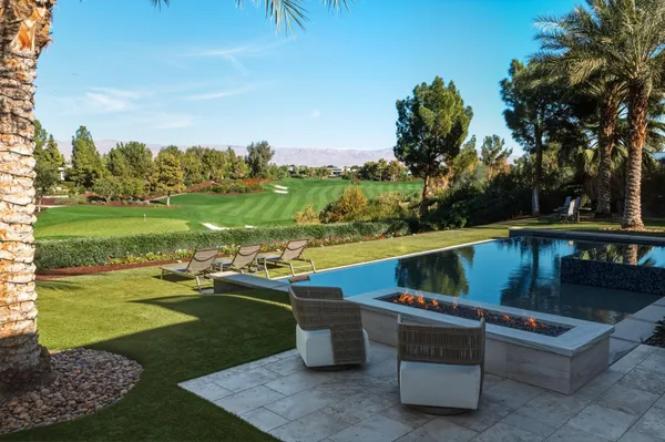 a view of a swimming pool and outdoor seating
