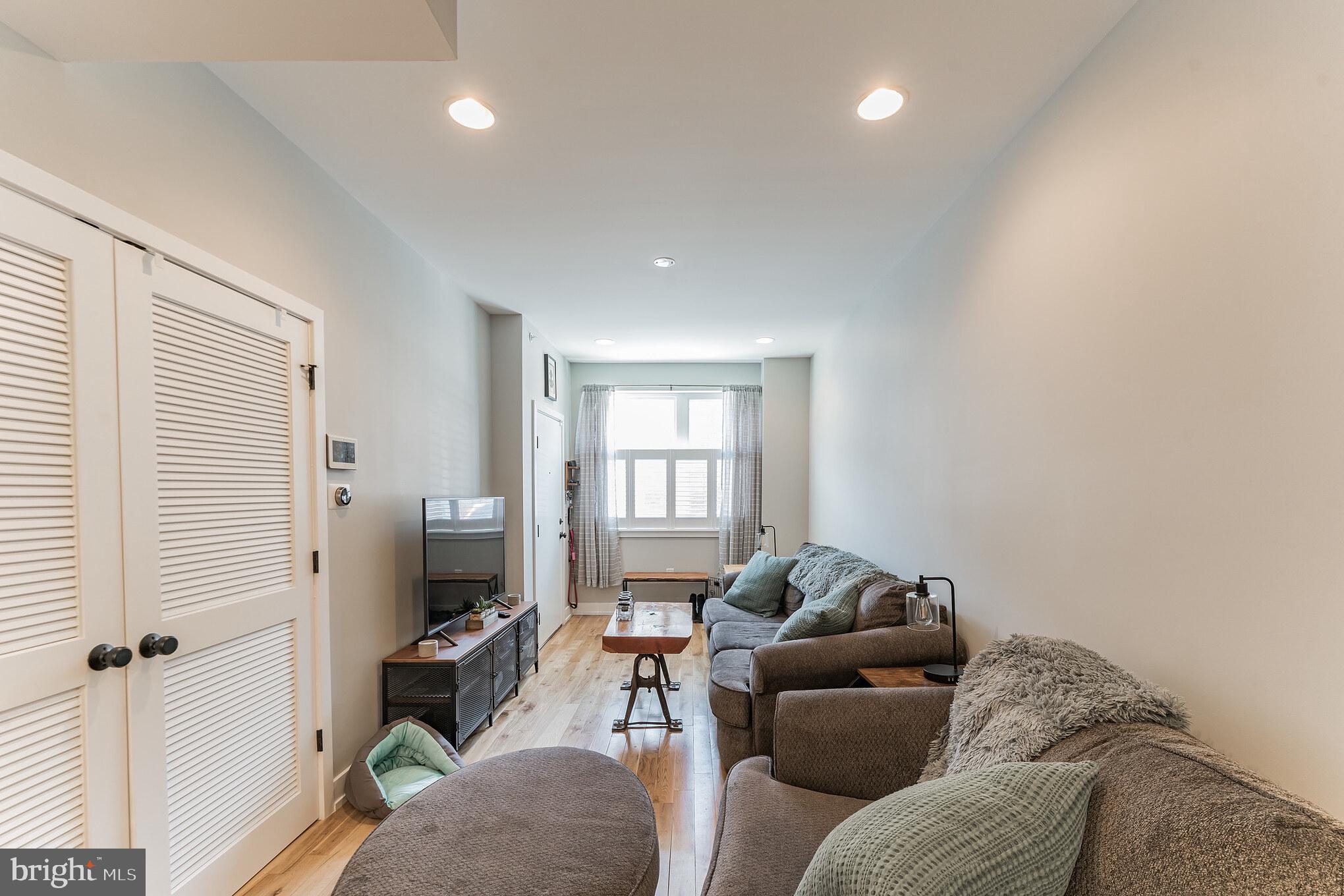 614 Master Street, Unit 1 Philadelphia, PA 19122 - Photo 13 of 28 a living room with furniture and a flat screen tv