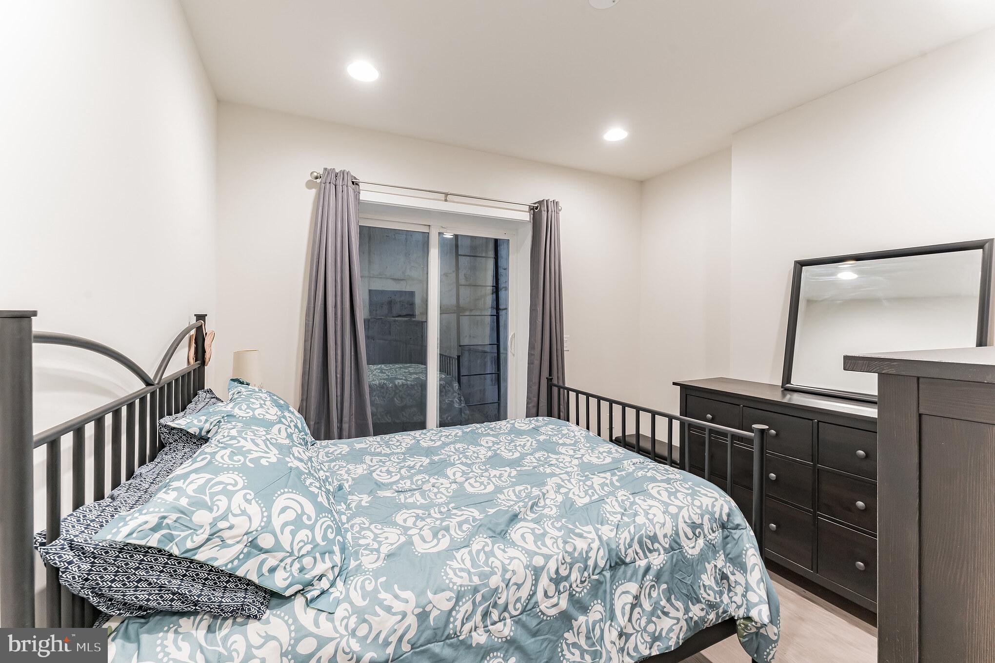 614 Master Street, Unit 1 Philadelphia, PA 19122 - Photo 16 of 28 a bedroom with a bed and wooden floor