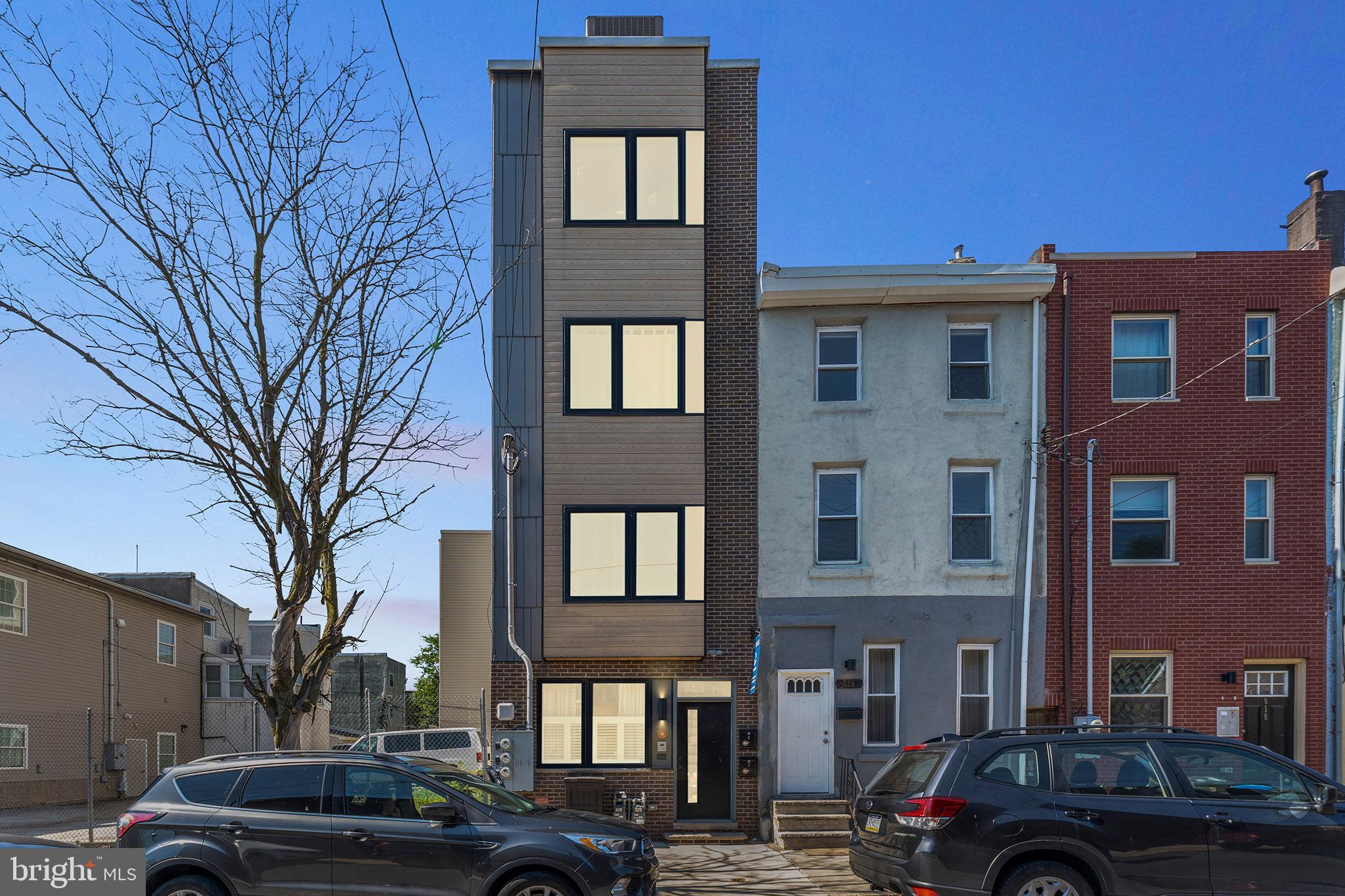 614 Master Street, Unit 1 Philadelphia, PA 19122 - Photo 2 of 28 a front view of a building with trees