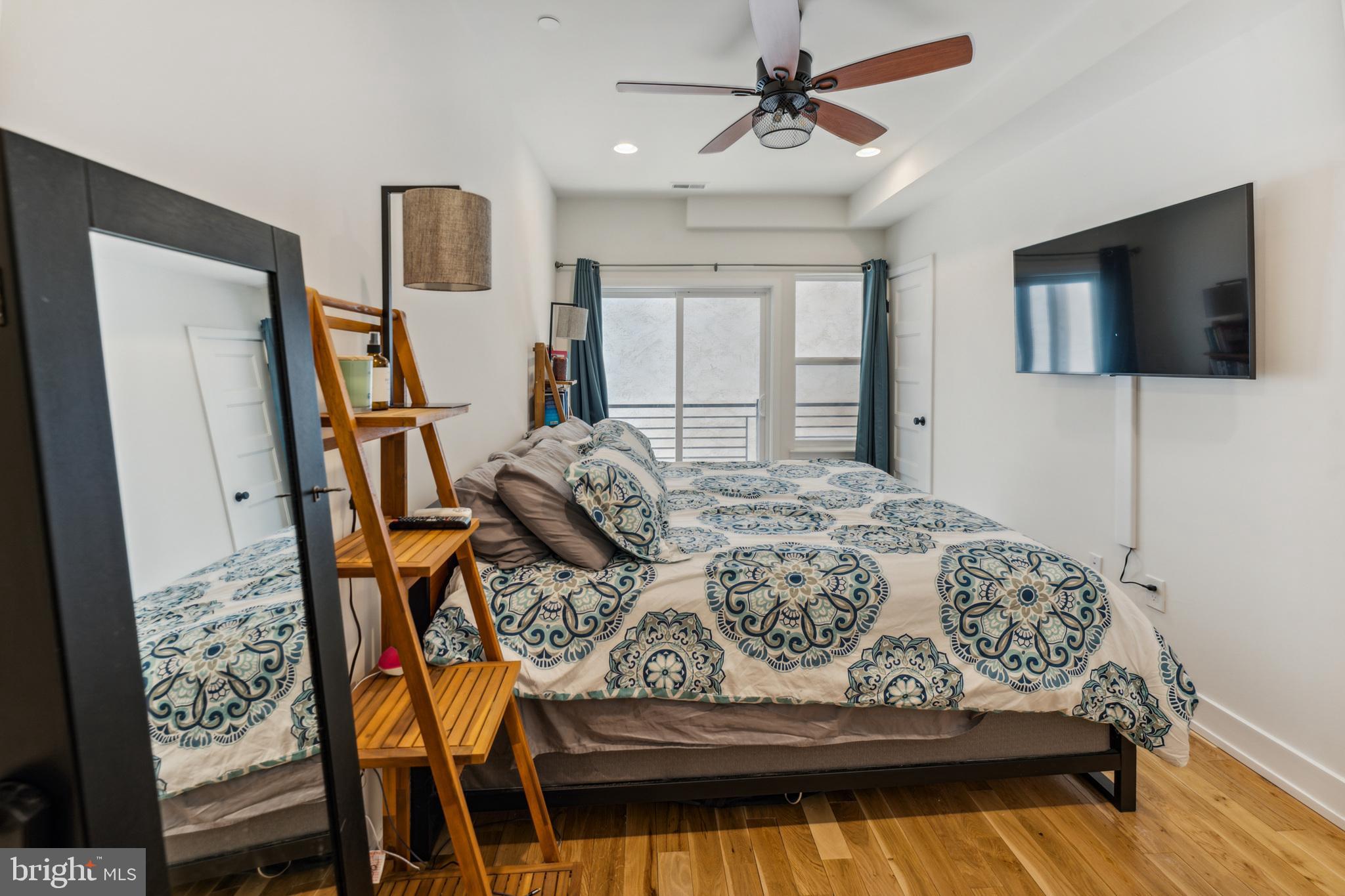 614 Master Street, Unit 1 Philadelphia, PA 19122 - Photo 21 of 28 a bedroom with a bed and a flat screen tv