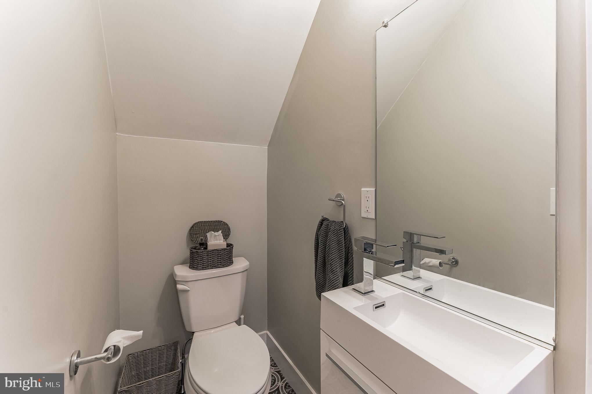 614 Master Street, Unit 1 Philadelphia, PA 19122 - Photo 26 of 28 a bathroom with a toilet sink and mirror