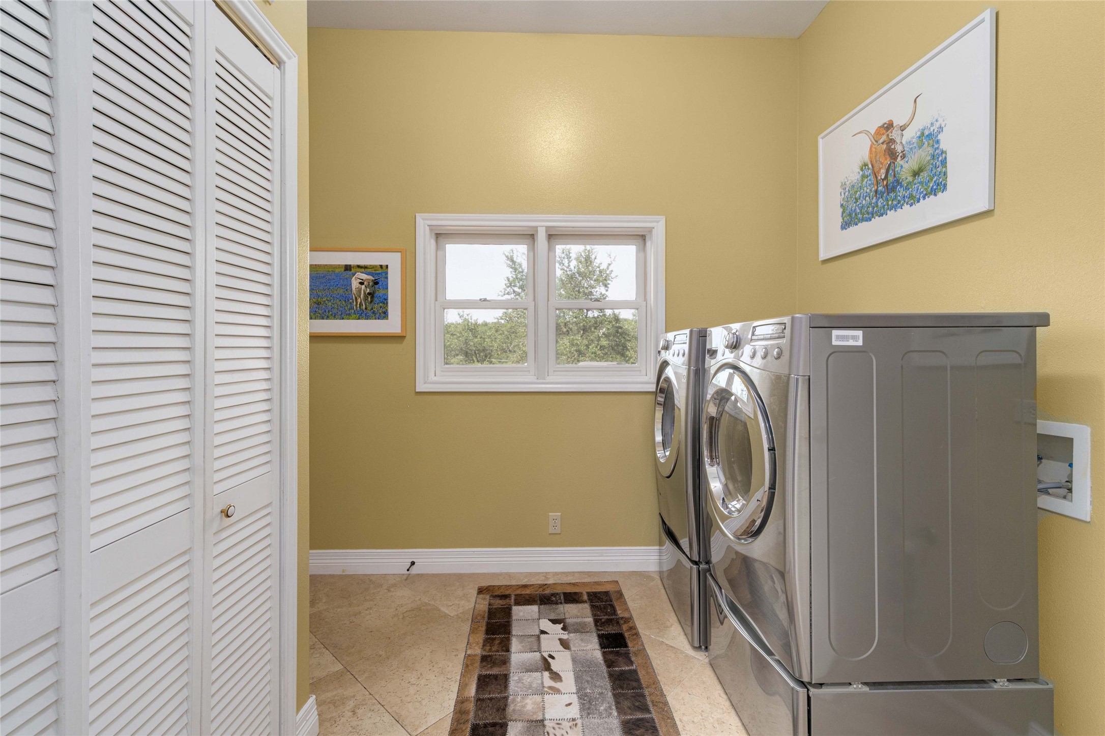 2102 Paisano Road Austin, TX 78746 - Photo 11 of 26 Laundry area with independent washer and dryer and light tile patterned floors