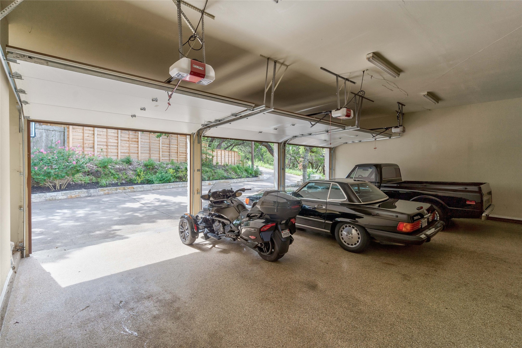2102 Paisano Road Austin, TX 78746 - Photo 19 of 26 Garage featuring a garage door opener