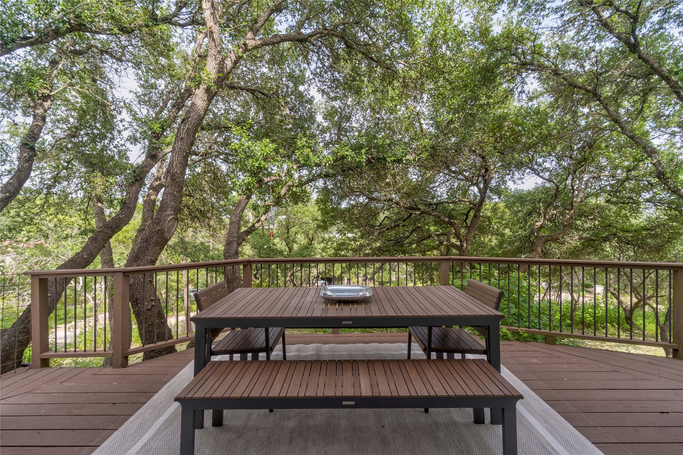 2102 Paisano Road Austin, TX 78746 - Photo 20 of 26 Wooden terrace with outdoor dining space