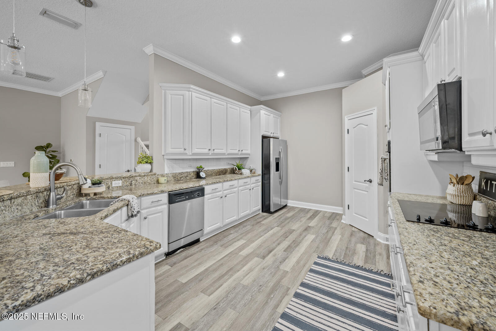 165 St John's Forest Boulevard St. Johns, FL 32259 - Photo 19 of 103 a kitchen with stainless steel appliances granite countertop a refrigerator stove oven and white cabinets