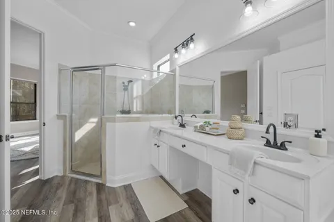 a bedroom with a bed and glass door