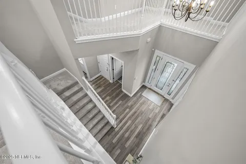 a front view of a house with a garden and trees