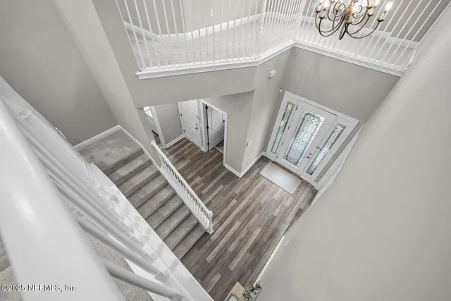 a front view of a house with a garden and trees