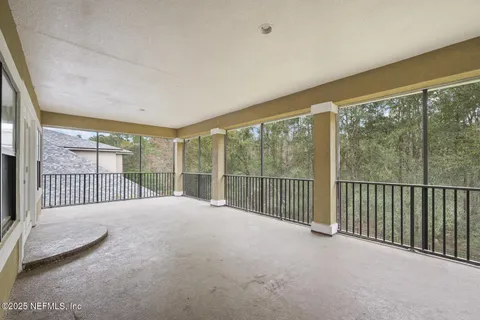 an aerial view of residential houses with outdoor space and ocean view