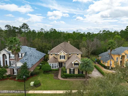 a living room with furniture a fireplace and a chandelier
