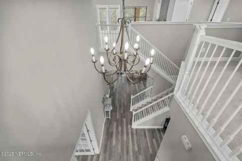 a view of a swimming pool with lawn chairs and a fire pit