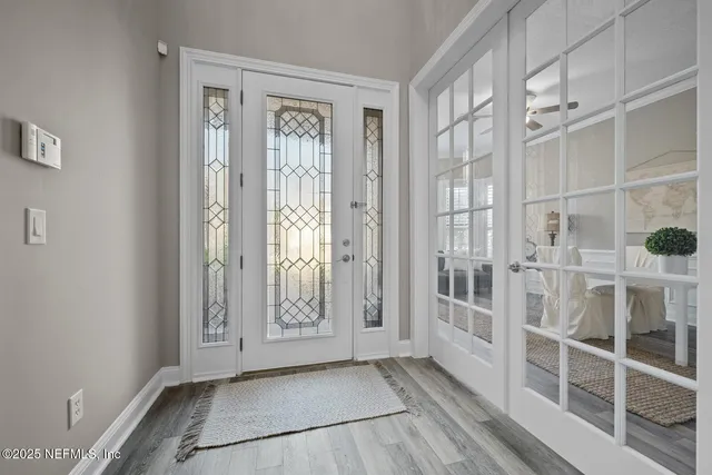 a kitchen with stainless steel appliances granite countertop a refrigerator stove oven and white cabinets