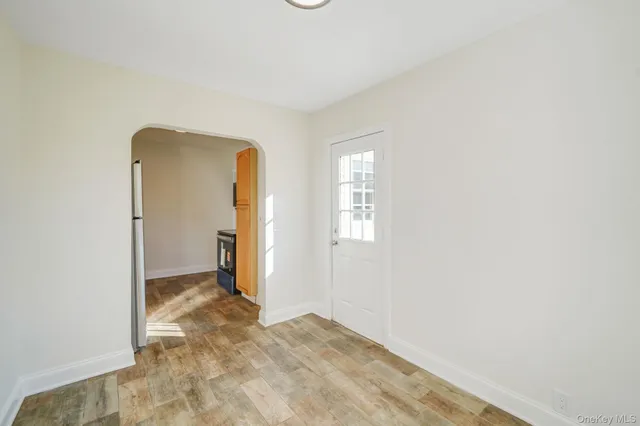 a view of a livingroom with wooden floor and a window