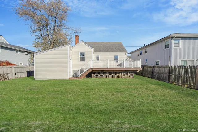 a view of backyard with barbeque grill and a fence