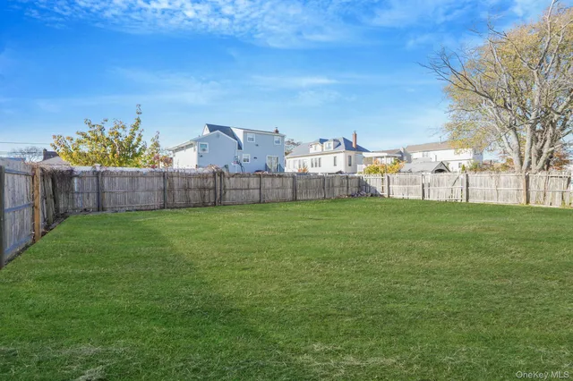 a view of a house with a big yard and large trees