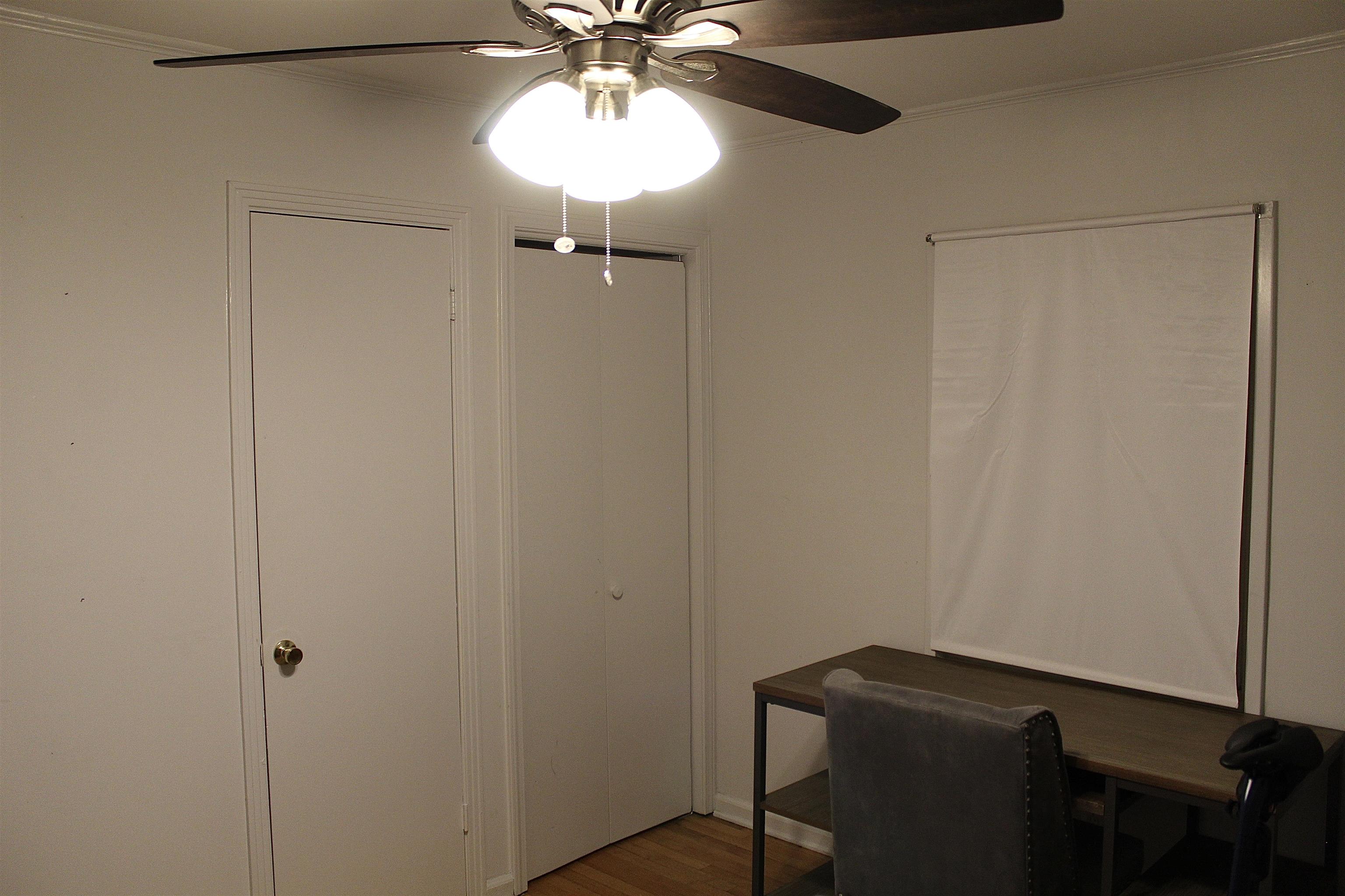 1715 Capri Road Memphis, TN 38117 - Photo 15 of 18 a view of a hallway with a table and chandelier fan