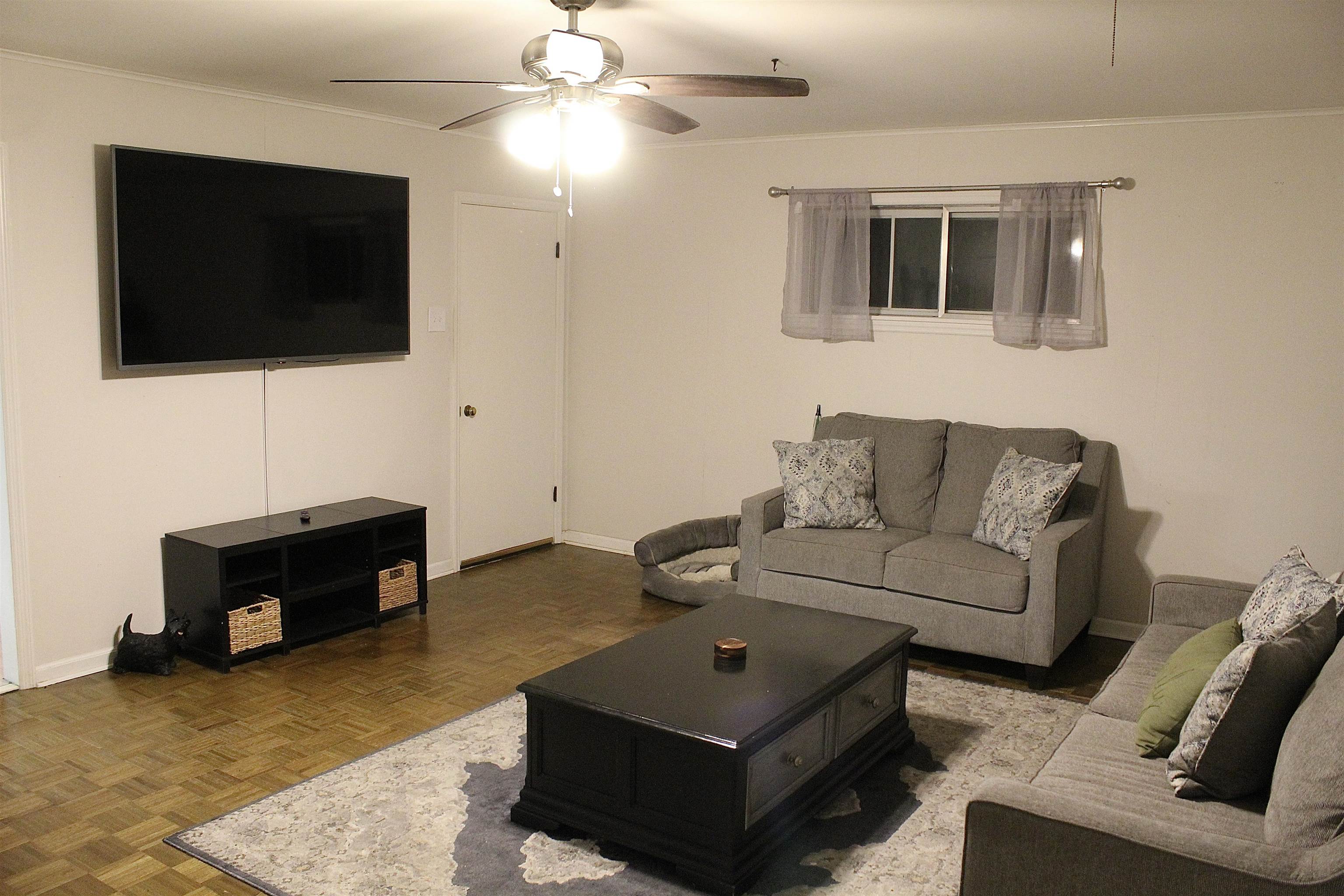 1715 Capri Road Memphis, TN 38117 - Photo 8 of 18 a living room with furniture and a flat screen tv