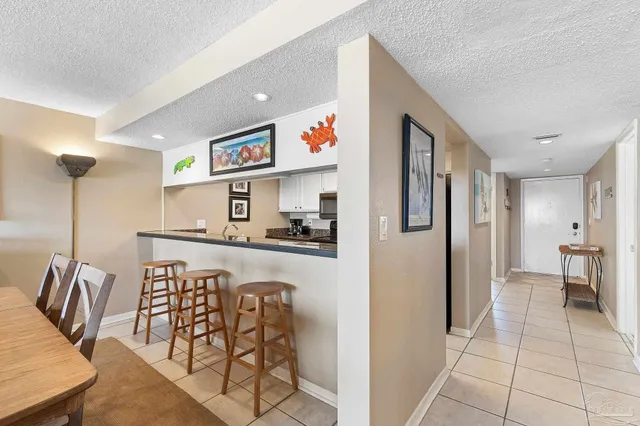 a view of kitchen with furniture and refrigerator