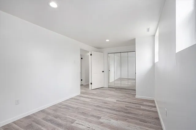 a view of an empty room and wooden floor