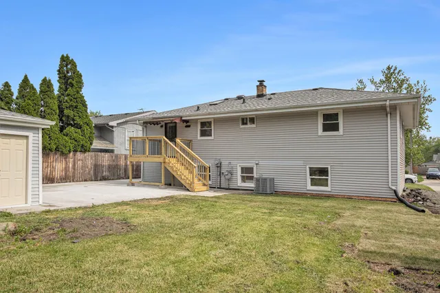 a view of a house with a yard and potted plants
