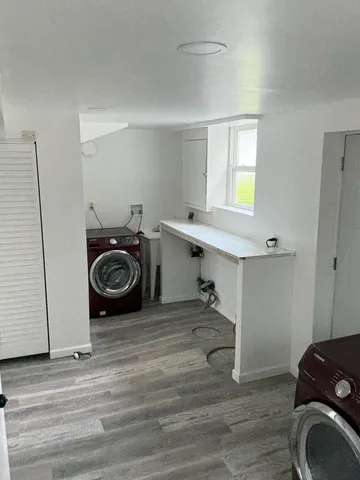 a utility room with cabinets dryer and washer