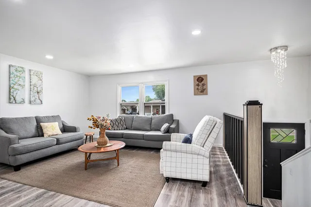 a living room with furniture and a wooden floor