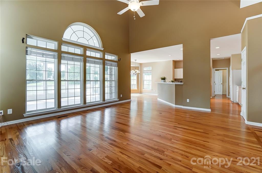 15922 Hollingbourne Road Huntersville, NC 28078 - Photo 13 of 48 a view of empty room with wooden floor and fan