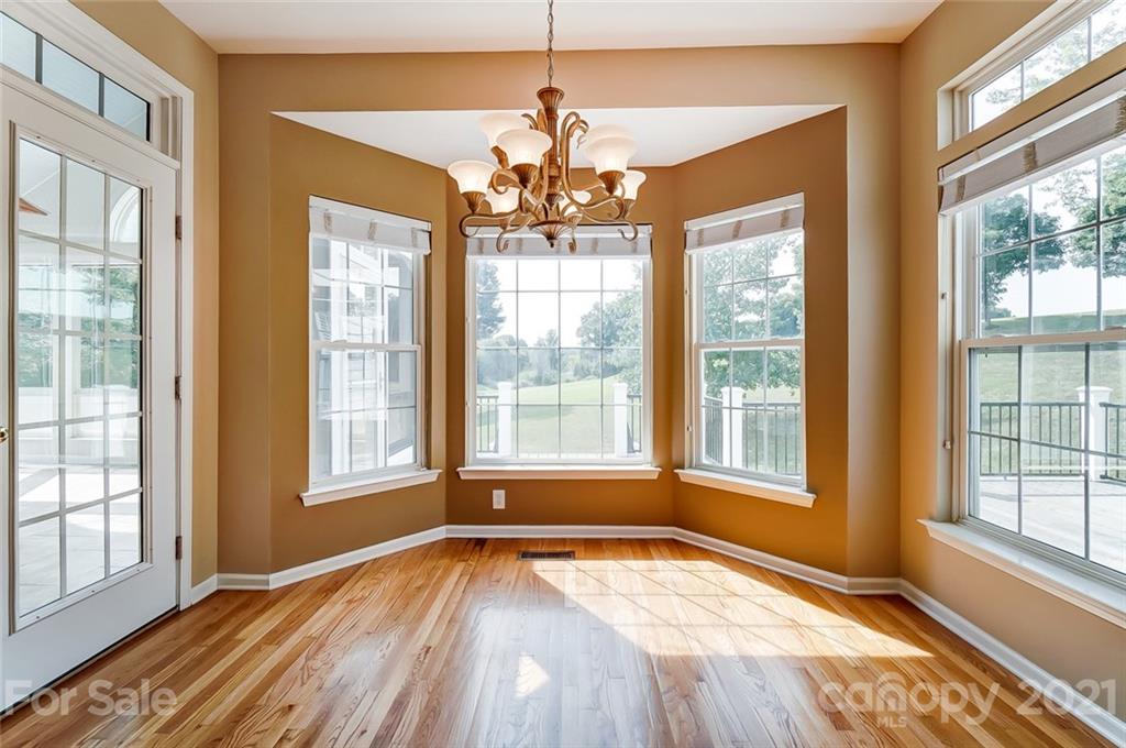 15922 Hollingbourne Road Huntersville, NC 28078 - Photo 14 of 48 a view of an empty room with wooden floor and a window