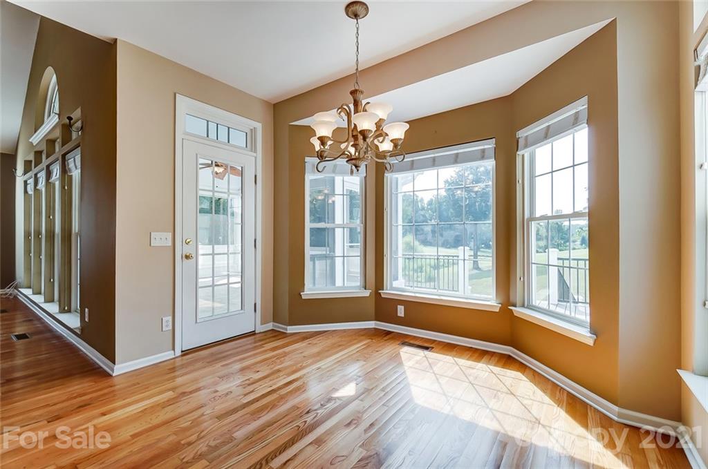 15922 Hollingbourne Road Huntersville, NC 28078 - Photo 15 of 48 a view of an empty room with a window and wooden floor
