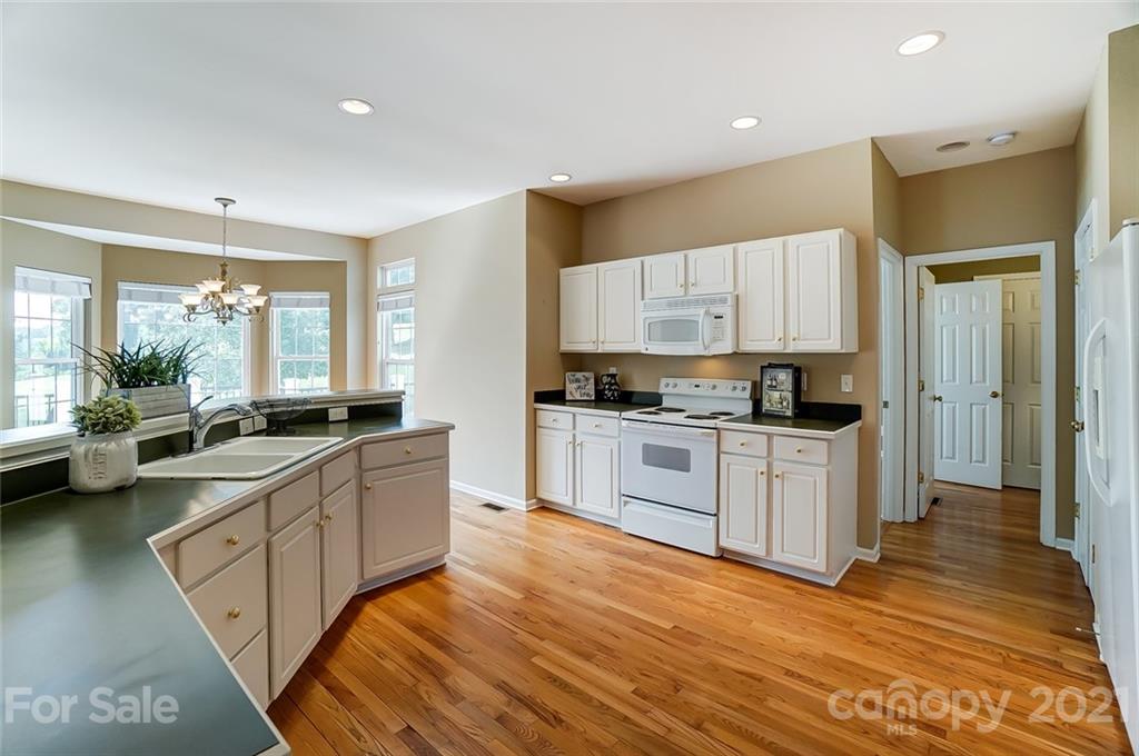 15922 Hollingbourne Road Huntersville, NC 28078 - Photo 22 of 48 a large kitchen with stainless steel appliances a large counter top a stove and a refrigerator