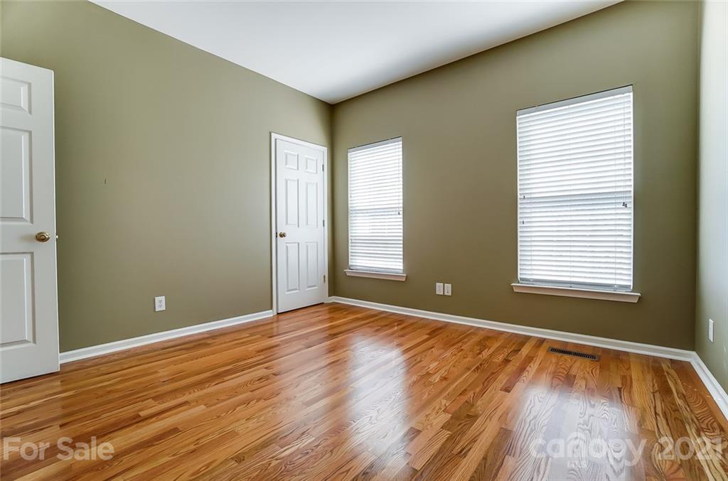 15922 Hollingbourne Road Huntersville, NC 28078 - Photo 23 of 48 a view of an empty room with wooden floor and a window