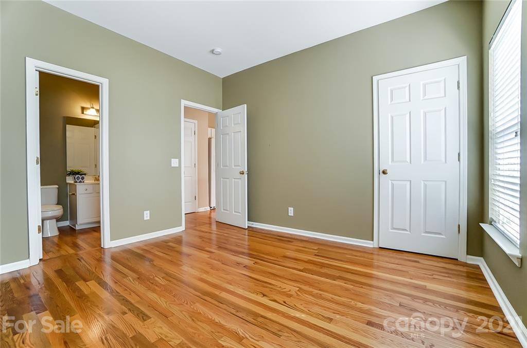15922 Hollingbourne Road Huntersville, NC 28078 - Photo 24 of 48 a view of an empty room with wooden floor and a window