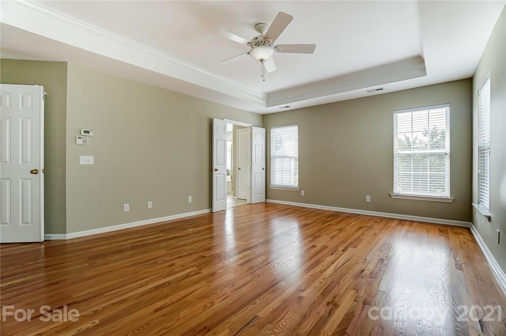 15922 Hollingbourne Road Huntersville, NC 28078 - Photo 29 of 48 an empty room with wooden floor and windows