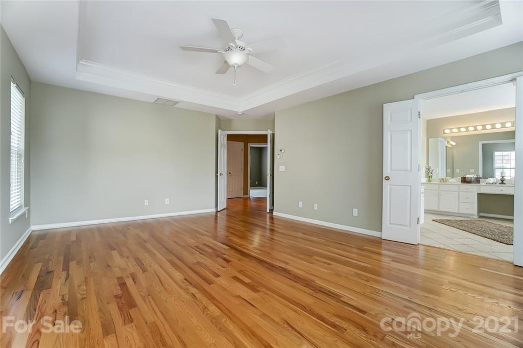 15922 Hollingbourne Road Huntersville, NC 28078 - Photo 30 of 48 a view of an empty room with wooden floor and a window