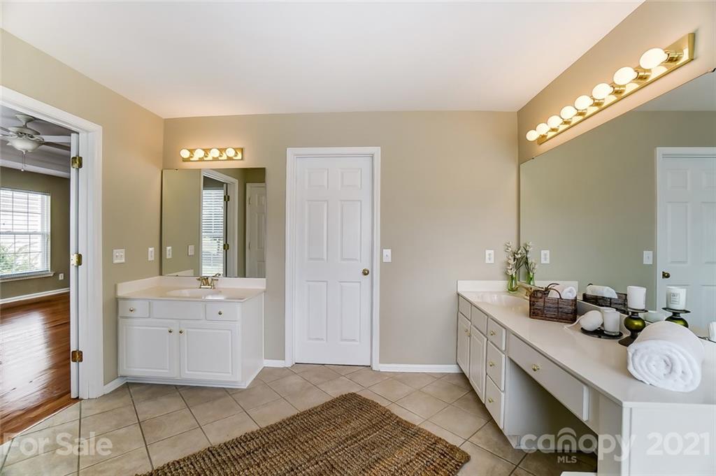 15922 Hollingbourne Road Huntersville, NC 28078 - Photo 32 of 48 a spacious bathroom with a double vanity sink and a mirror