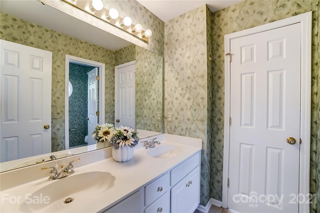 15922 Hollingbourne Road Huntersville, NC 28078 - Photo 35 of 48 a bathroom with a sink double vanity and a mirror