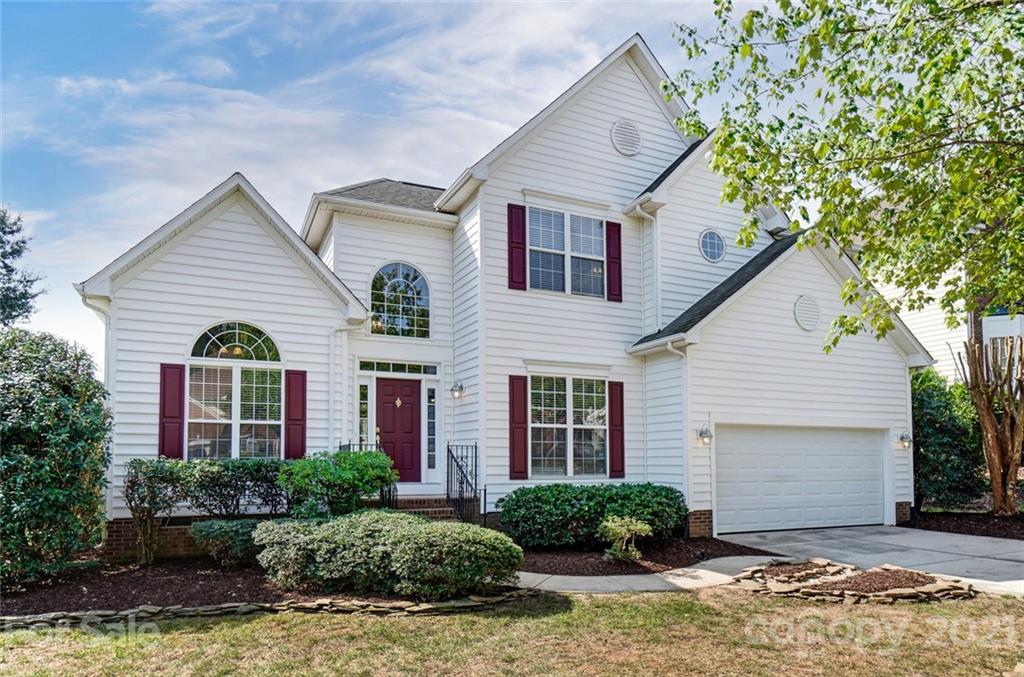 15922 Hollingbourne Road Huntersville, NC 28078 - Photo 7 of 48 a front view of a house with a yard and potted plants