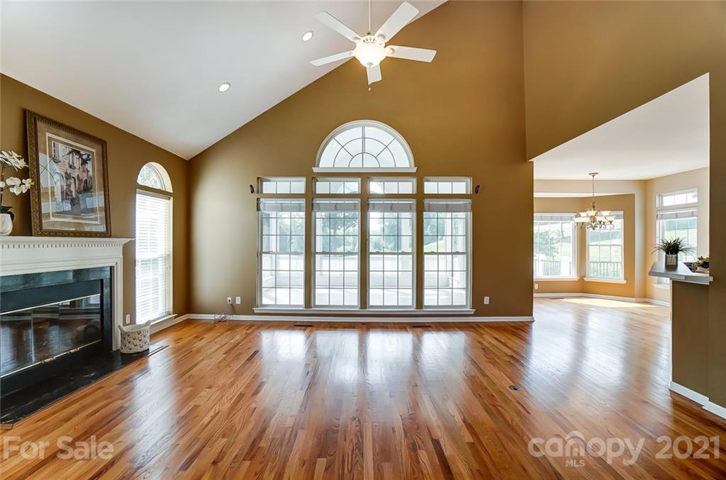 15922 Hollingbourne Road Huntersville, NC 28078 - Photo 8 of 48 a view of an empty room with wooden floor fireplace and a window