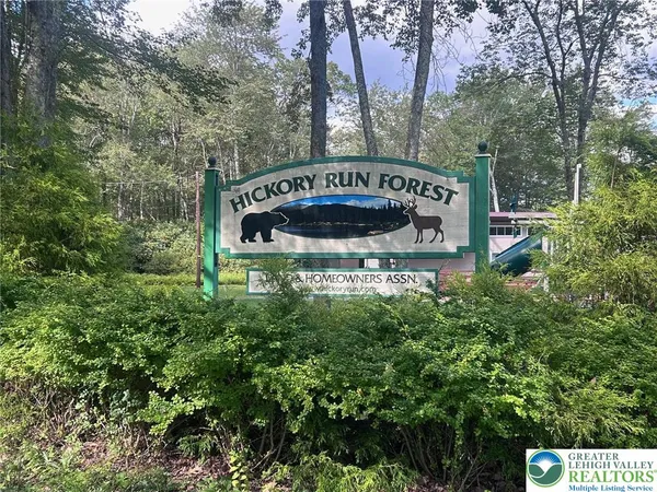 a view of street sign under a tree