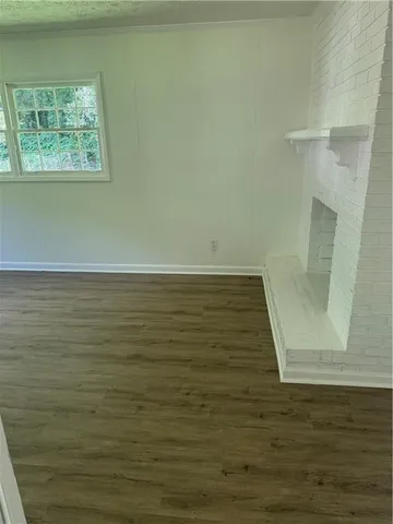 a view of a room with wooden floor and cabinet