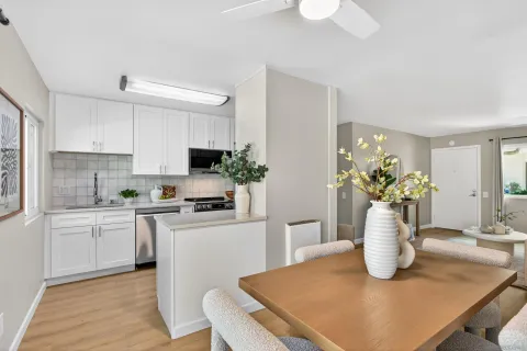 a kitchen with a white stove top oven and white cabinets