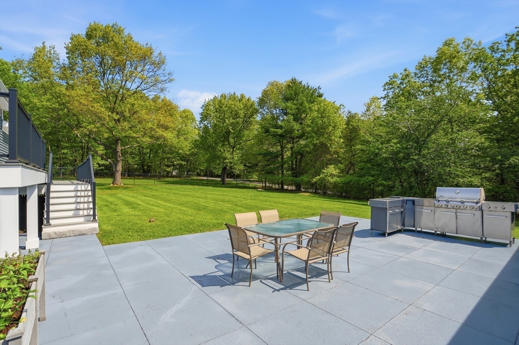 235 Kemp Street Dunstable, MA 01827 - Photo 37 of 42 a view of a chairs and table in the back yard of the house