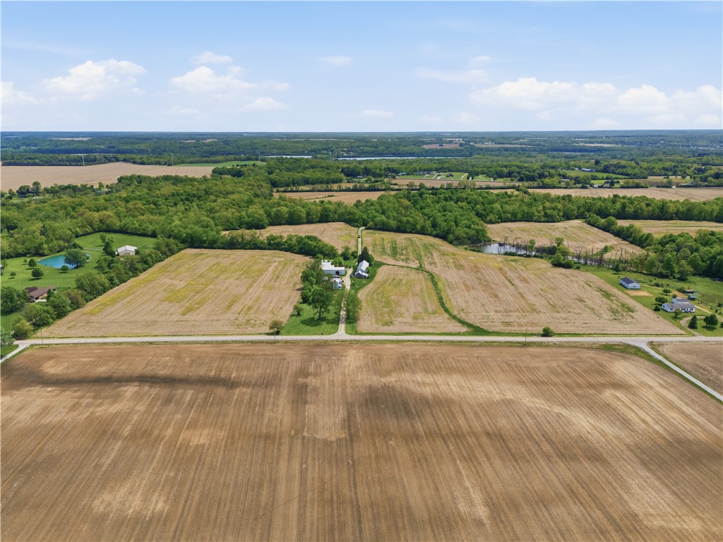 Lot 2 Penewit Road Spring Valley, OH 45370 - Photo 3 of 3 Expansive agricultural landscapes unfold, offering vast open fields and serene ponds under an open sky.