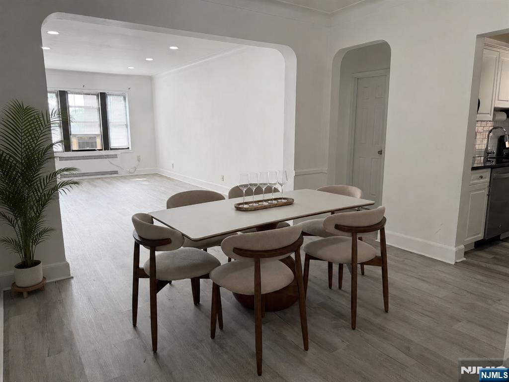 100 Prospect Avenue, Unit 2E Hackensack, NJ 07601 - Photo 5 of 16 a view of a dining room with furniture and wooden floor