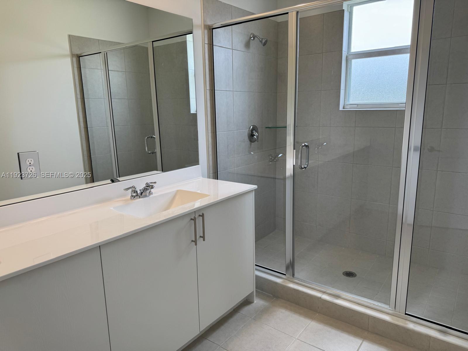 18406 Southwest 2nd Street Pembroke Pines, FL 33029 - Photo 13 of 15 a bathroom with a shower sink and mirror