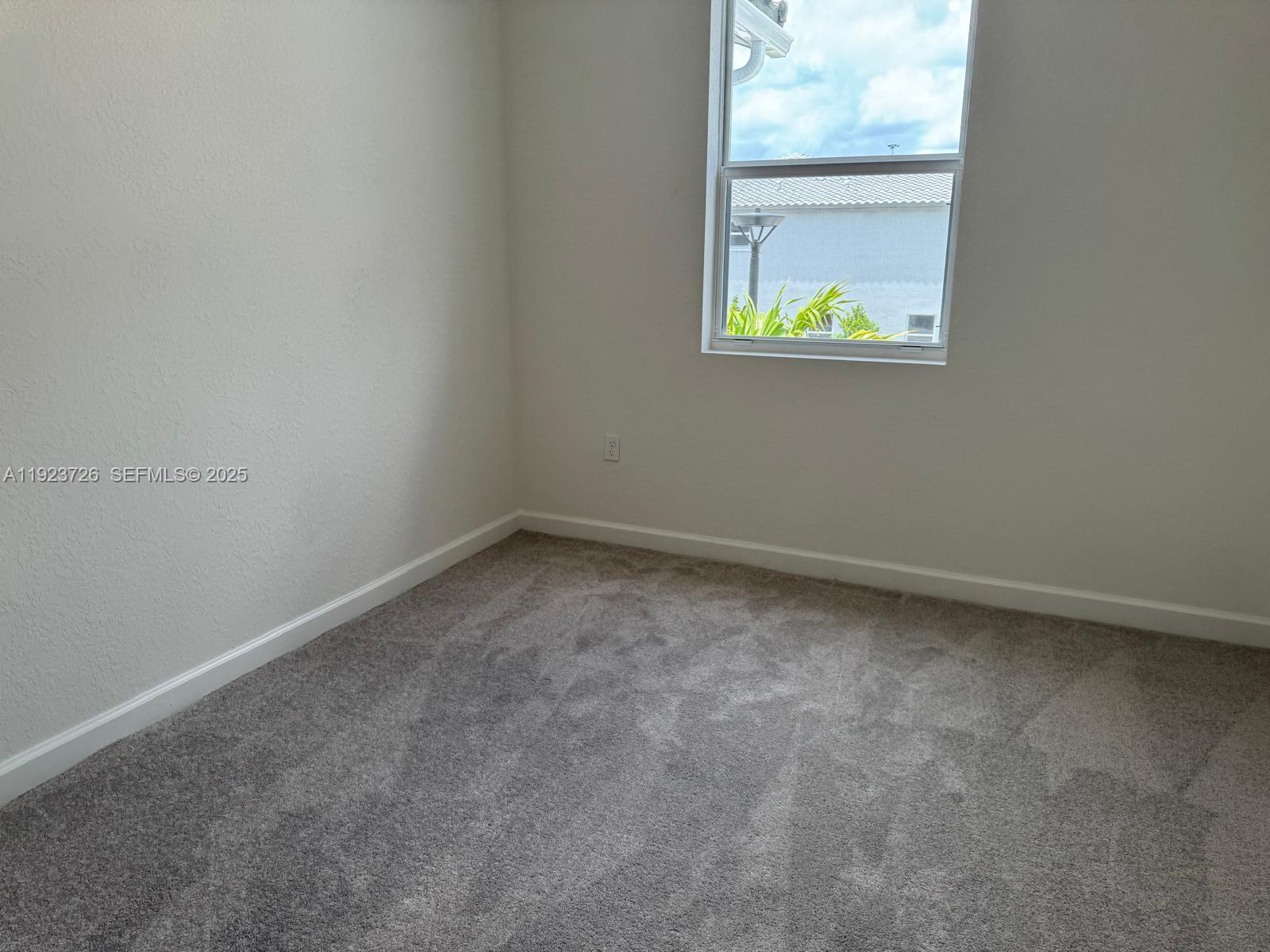 18406 Southwest 2nd Street Pembroke Pines, FL 33029 - Photo 3 of 15 an empty room with a window