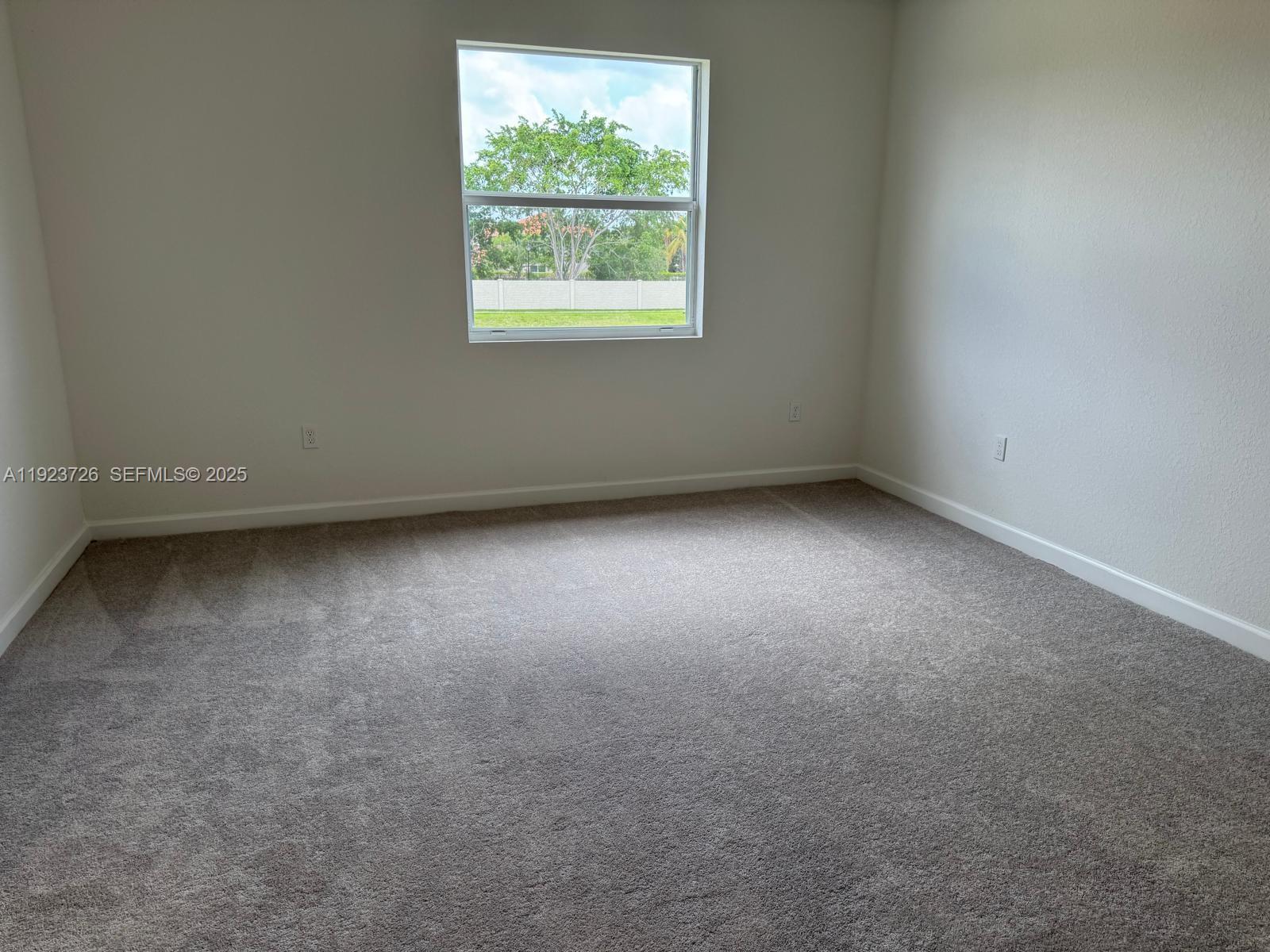 18406 Southwest 2nd Street Pembroke Pines, FL 33029 - Photo 5 of 15 an empty room with a window